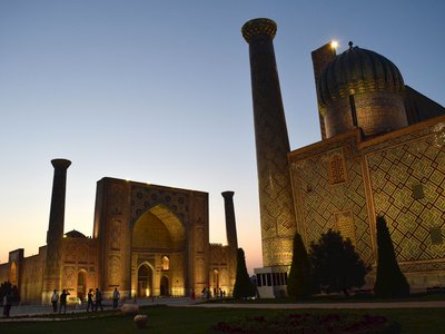 Historical landmark Registan Square at night time with highly decorated buildings lit by artificial light below, Samarkand, Uzbekistan
