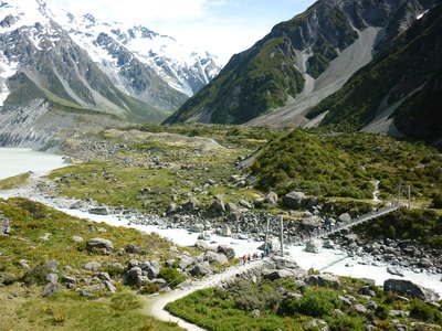 Ramble Worldwide walking holiday group walking over Lower Hooker Suspension Bridge near Lake Matheson, Mount Cook walking tour, New Zealand