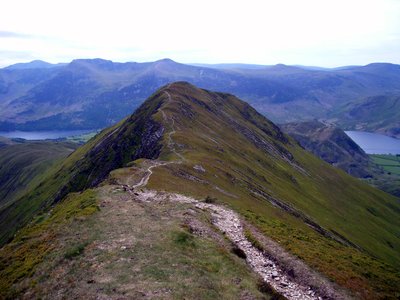 Ridge of Sail peak in the Lake District wit stone pathway lined across, lying between Derwentwater and Crummock Water
