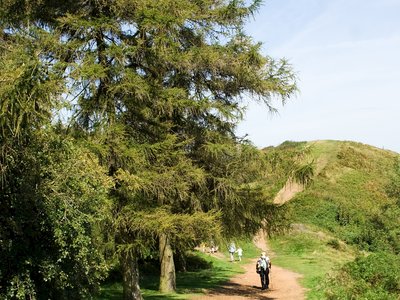 Hiker walking up Malvern Hills, UK