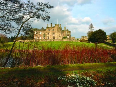 Ripley Castle atop hill viewed from distance in Spring, North Yorkshire