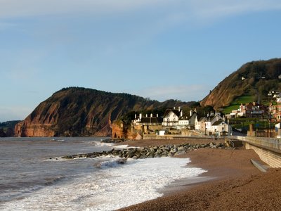 Thatched roofed houses beside the beach and sea wall in Sidmouth, England