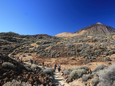 Ramble Worldwide walking group ascending dirt pathway to Mount Teide, Tenerife, Canary Island