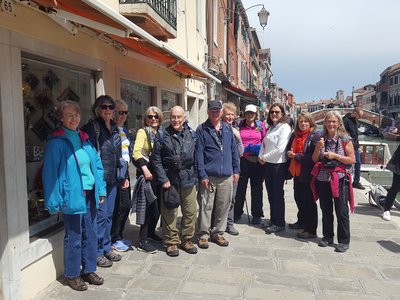 Ramble Worldwide walking group on walking holiday Venice Unmasked stood on pavement by canal, Venice, Italy