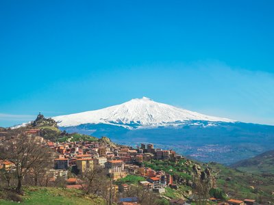 Messina city in Sicily with stratovolcano Mount Etna in background, Italy