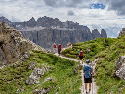 Hikers following mountain pathway in the Dolomites mountain range, Italy