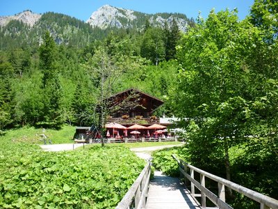 Beer garden at the bottom of the Tegelberg mountain amidst green trees, Bavaria, Germany.jpg
