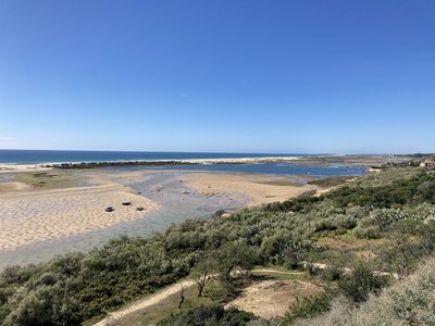 High view of Tavira Salt Pans with meandering pathways below in Santa Luizia, Portugal