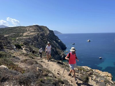 People on Ramble Worldwide walking holiday walking along coastal pathway with seaview on sunny day, Calvi, Corsica, Commune in France