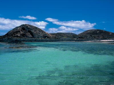 Turquoise waters and small island in distance, Lobos Island, Canary Islands, Spain