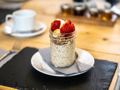 Hassness House Breakfast strawberries, muesli, and yoghurt presented in jar on table
