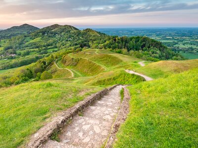 Stone stairs descending across Malvern hills with green rolling hilly landscape, Malvern
