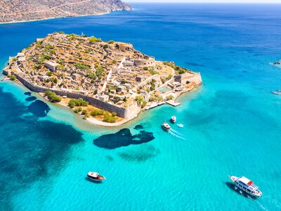 Island of Spinalonga with calm turquoise waters surrounding, gulf of Elounda, Crete, Greece