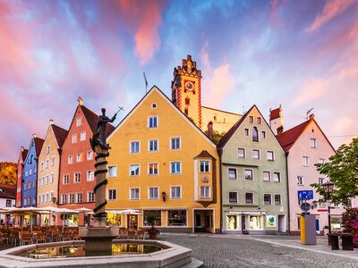 Old townscape during sunset with striking pink clouds above town colourful town houses, Fussen, Germany