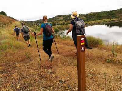 Group of 4 walkers walking uphill, Caldeirao, Algarve, Portugal