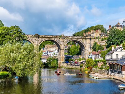 Low view along the River Nidd towards the viaduct in the town of Knaresborough in Yorkshire, UK