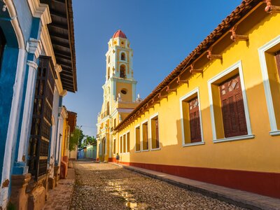 Colourful vibrant yellow bell tower of St Francis church in Trinidad - a UNESCO World Heritage site, Cuba, Caribbean
