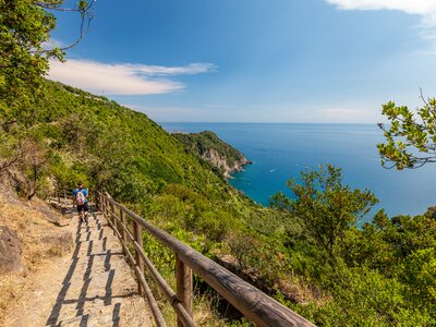 Male hiker descending Cinque Terre route from Vernazza village to Corniglia village, Liguria, Italy