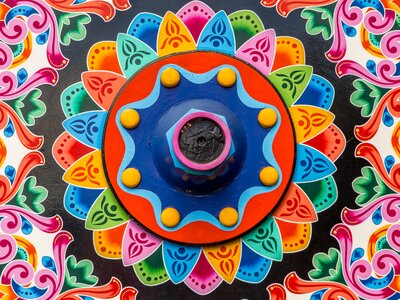 Close up of geometric and colourfully decorated traditional coffee transport cart wheel, Costa Rica