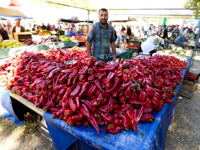 Man selling red peppers at St Paul Market, Turkey