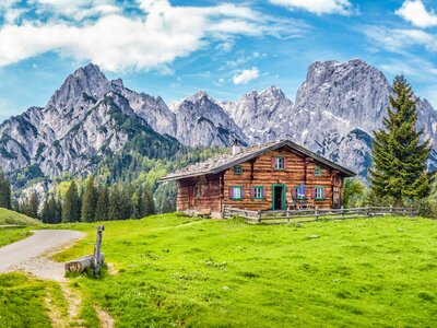 Scenic mountain landscape in the Alps with traditional old mountain chalet and fresh green meadows in springtime, Germany