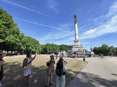 People standing in shade admiring historical landmark Monument aux Girondins, Bordeaux, France