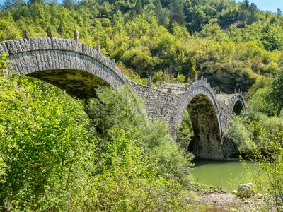 Three arches stone bridge of Kalogeriko (or Plakida) near the villages of Kipi and Koukouli in the Central Zagori, Greece