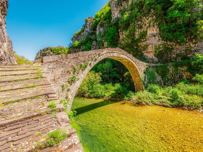 Kokkorou bridge, medieval stone bridge on river of Voidomatis, Pindus Mountains, Zagori, Greece