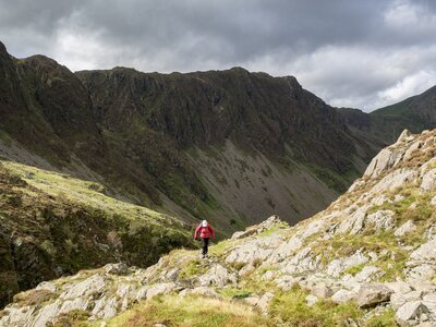 Person hiking up rocky fell, Lake District