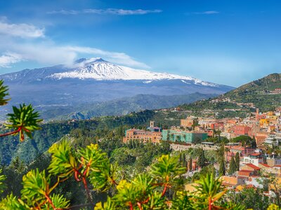 Mount Etna volcano and Taormina town aerial panoramic view, Taormina, Sicily, Italy