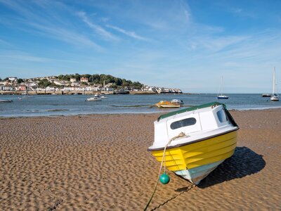 Yellow boat during low tide at shore, Instow, north coast of Devon