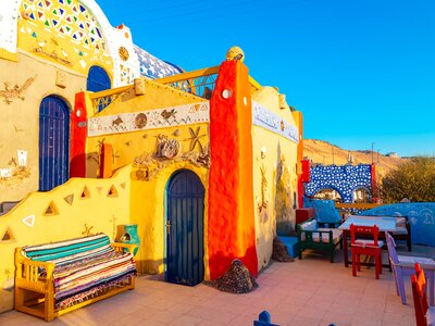 Dawn in colourful Nubian village with many unique shapes and decorations on handmade buildings, Aswan, Egypt