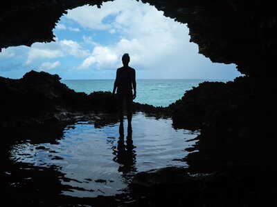 Person standing in coastal Animal Flower cave at North Point of the Caribbean, Barbados