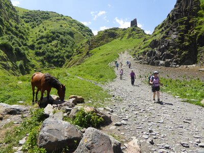Hikers descending pathway from Gergeti trinity church trail, Kazbegi, Georgia