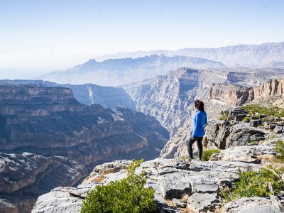 Solo woman hiking in Jabel Shams, Wadi Ghul, Grand Canyon of Arabia, Oman, Middle East, Asia