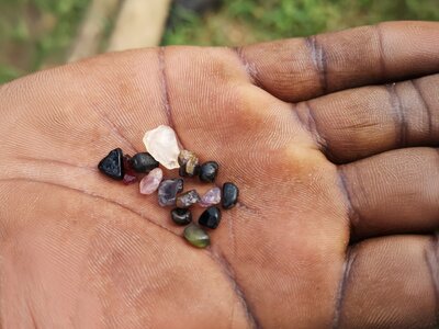 Gem stones on palm of hand from recent mining, Sri Lanka