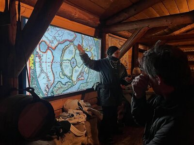 Students studying an old map to learn about Svalbard