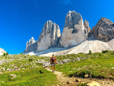 Summer hike on a scenic trail leading to the majestic tre cime di lavaredo peaks in the dolomites, Italy