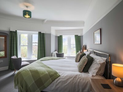 Hassness House bedroom with pebble stone and lichen green colour scheme in well-lit room, Lake District, Cumbria, England