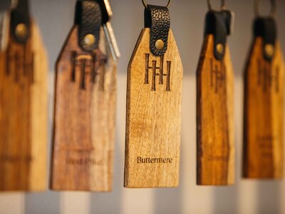 Close-up of handing keys of Hassness House with high quality detailed etching of logo and named rooms
