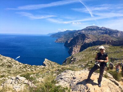 Ramble Worldwide walking holiday leader Avril McAllister by coast on sunny day