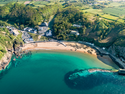 Aerial view of Greve de Lecq showing golden sand beach with turquoise waters, Jersey