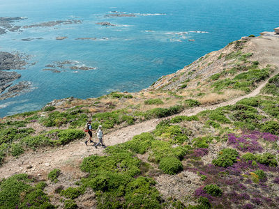 Aerial view of couple walking along coastal path, Battery Molke, L'etacq, Jersey