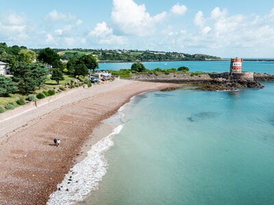 Aerial view of couple walking along beach, Archirondel, St Catherine, Jersey