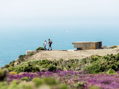 Two people walking by L'Etacq, St Ouen, Jersey