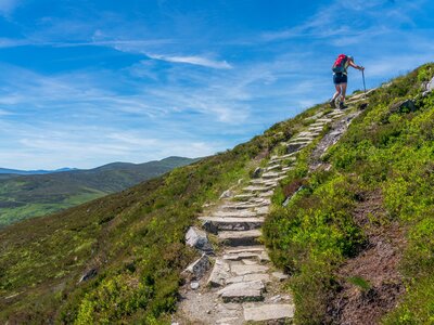 Woman hiking up stone-path hill
