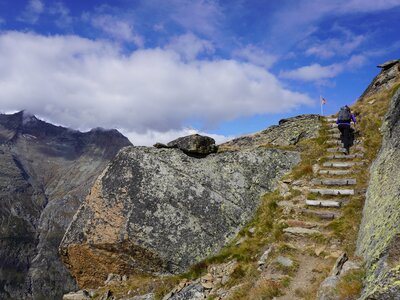 Person hiking up stone stairway at Saas-Almagell, part of Saas Valley, Switzerland