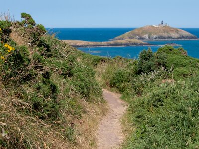 Ballycotton cliff walking trail path with view to Ballycotton Lighthouse in far distance, East Cork, Ireland