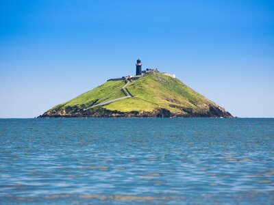 Ballycotton Lighthouse with blue sea and clear blue sky on sunny day, Cork, Ireland