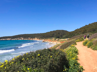 Hikers walking along coastal path in Menorca, Balearic Islands, Spain